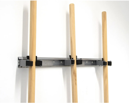 Support d'outils avec manches en bois sur un mur