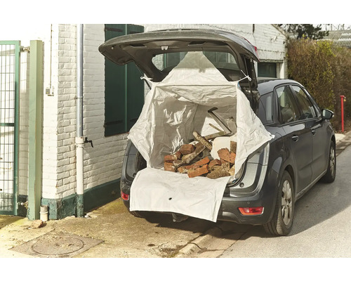 Voiture avec hayon ouvert, chargée d'un big bag rempli de briques et de gravats
