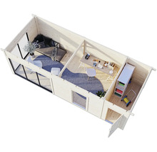 Vue intérieure d'un abri de jardin avec salon, espace de travail et espace de stockage.