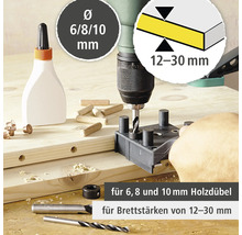 Perceuse à bois en utilisation avec des chevilles, de la colle et des forets