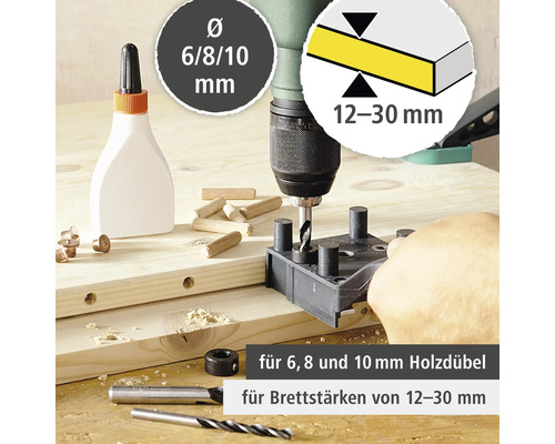 Perceuse à bois en utilisation avec des chevilles, de la colle et des forets