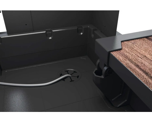 Intérieur d'un coffre de jardin avec passage de câble