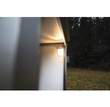 Éclairage intérieur LED brillant monté sur la paroi à l'intérieur d'un abri de jardin en métal dans un jardin.