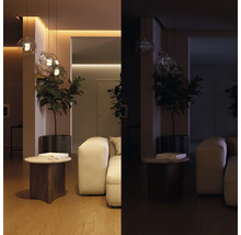 Comparaison d'un salon moderne éclairé et sombre, avec des suspensions en verre, une plante et un canapé blanc.