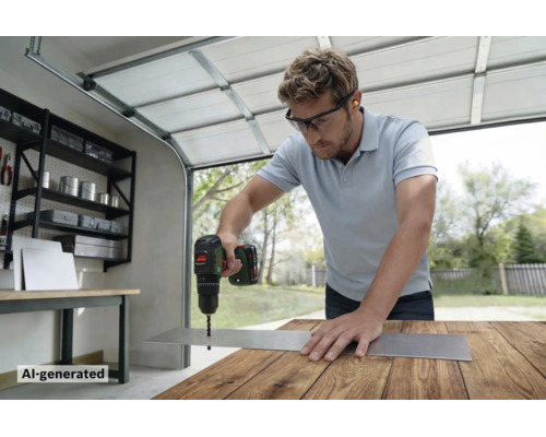 Artisan perçant un trou dans une plaque métallique avec une perceuse sans fil Bosch sur un établi dans un garage.