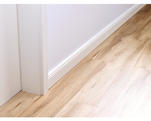 Gros plan d''une pièce avec des plinthes et un sol stratifié.