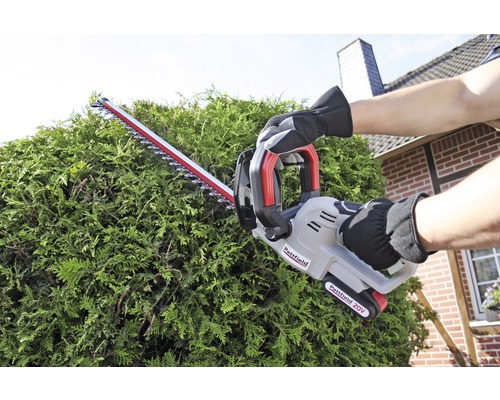 Eine Person schneidet eine Hecke mit einer Akku-Heckenschere von Pattfield.