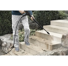 Person reinigt Steintreppe mit Hochdruckreiniger