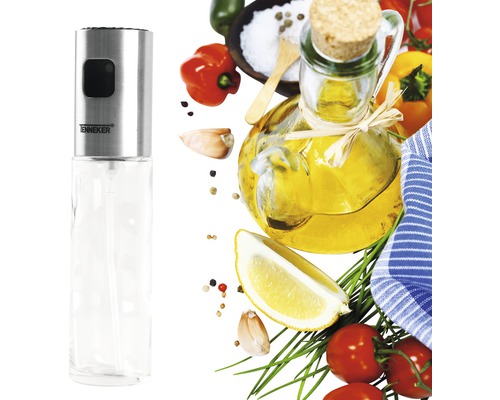 Pulvérisateur d''huile en acier inoxydable et en verre avec divers ingrédients en arrière-plan