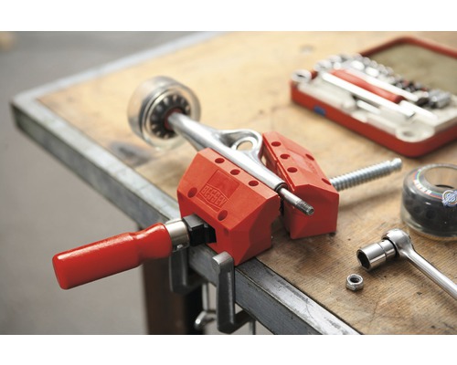 Essieu de skateboard serré dans un étau sur un établi