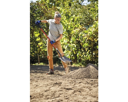 Femme travaille avec une bêche dans le jardin