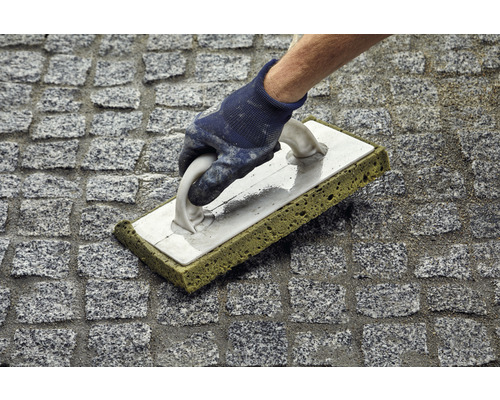 Nettoyage des joints de pavés avec du caoutchouc à joints