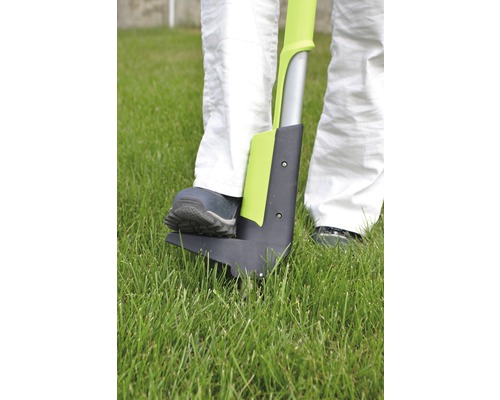 Une personne utilise un désherbeur dans le jardin