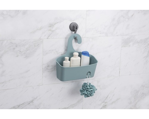 Étagère de douche avec ventouse sur un mur carrelé, remplie de produits de soins et d''une fleur de douche
