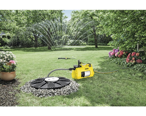 Garten mit Gartenpumpe, Erdbegrenzung und Rasensprenger
