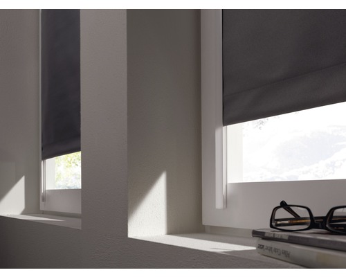 Zwei Fenster mit grauen Rollos, die teilweise geschlossen sind