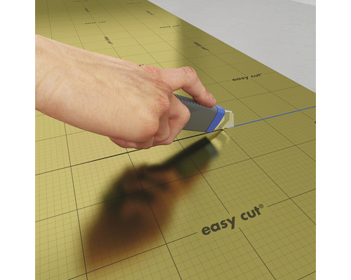 La sous-couche isolante est coupée à la taille avec un cutter