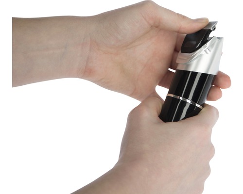 Hände bedienen einen Haarschneider