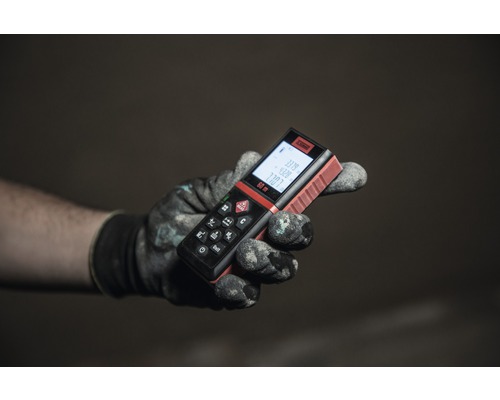 Une main gantée tenant un télémètre