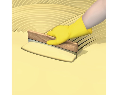 Application de la colle à carrelage avec une spatule