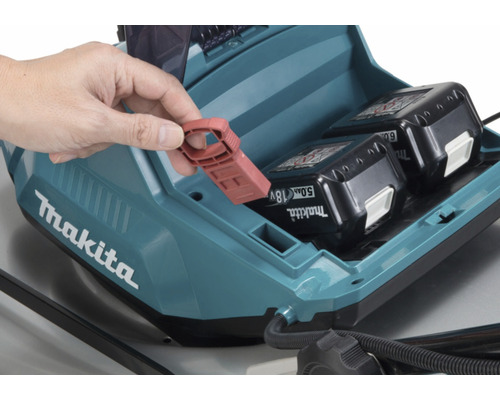 Makita Aufbewahrungsbox mit zwei Akkus und Person, die einen roten Gegenstand hält