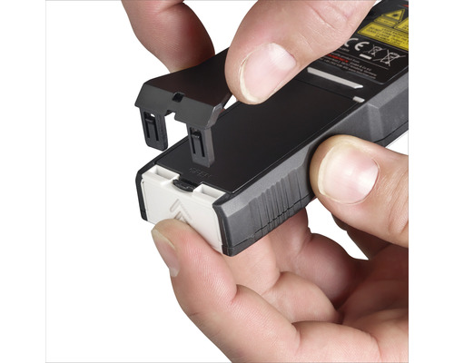 Insertion du couvercle du compartiment à piles dans un appareil de mesure électronique