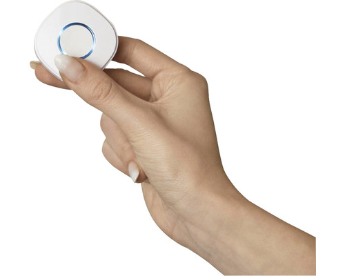 Une main tient un interrupteur sans fil rond