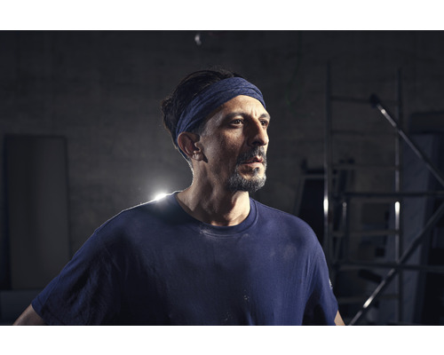 Artisan avec bandeau et vêtements de travail.