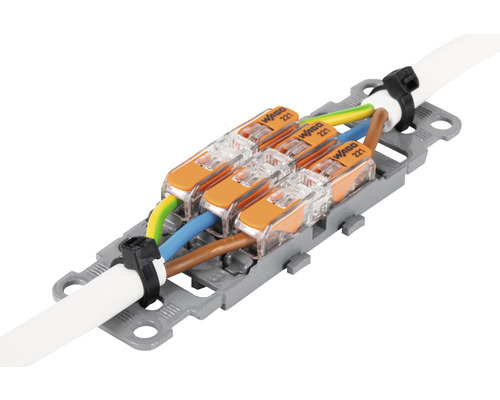 Wago Verbindungsklemmen der Serie 221 mit drei elektrischen Leitungen in einer Halterung.