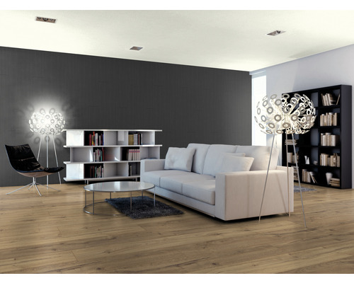 Wohnzimmer mit Sofa, Bücherregal, Stehlampe und Laminatboden.