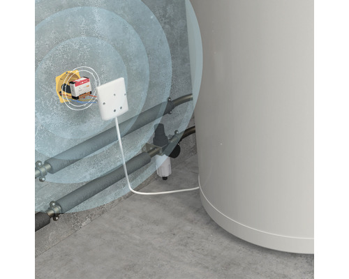 Installation d''un détecteur de fuites dans un local de chauffage avec des tuyaux et une chaudière.