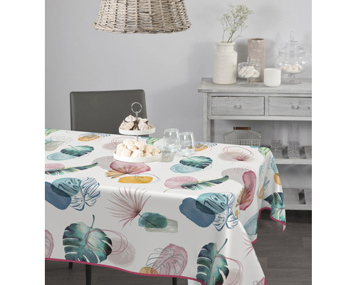 Nappe Veniline Playful leaves 140 cm de largeur (au mètre) Table avec une nappe imprimée de motifs végétaux dans une salle à manger