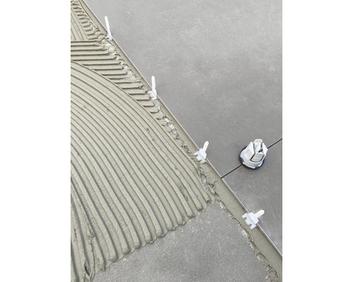 Outil de carreleur avec système de nivellement sur colle fraîche entre les carreaux