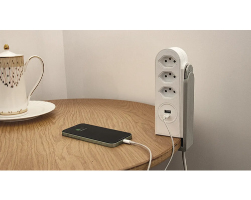 Multiprise avec connexion USB sur une table avec un téléphone portable en charge