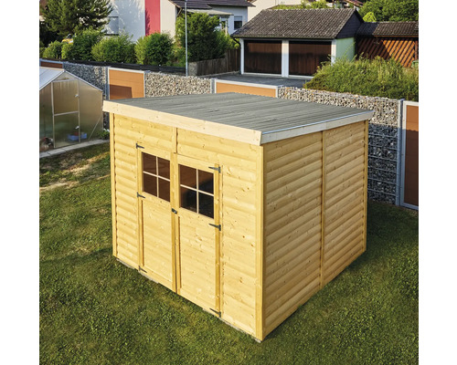 Abri de jardin en bois avec toit plat et double porte dans le jardin