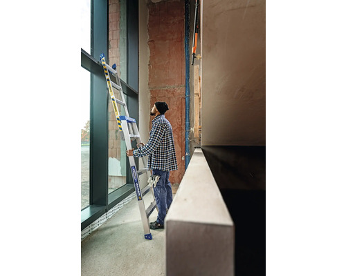 Artisan avec escabeau dans un bâtiment en gros œuvre