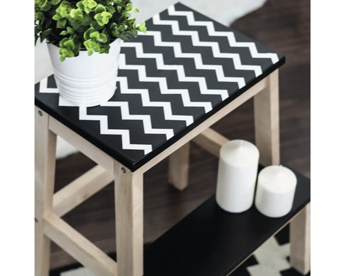 Tabouret en bois avec motif en zigzag, plante et bougies