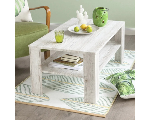 Table basse avec compartiment de rangement et décorations sur un tapis