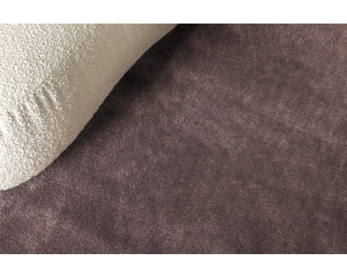 Nahaufnahme eines braunen Teppichs mit einem Kissen.