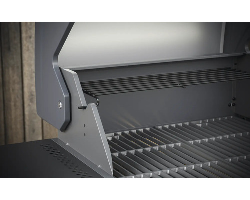 Vue intérieure d''un barbecue à gaz avec grille et support de maintien au chaud.