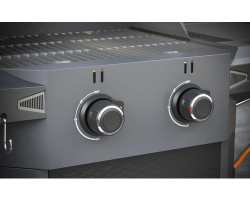 Gros plan d''un barbecue à gaz avec deux boutons rotatifs pour régler la température