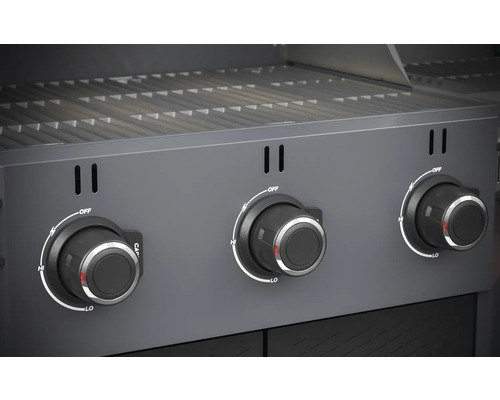 Gros plan d''un gril à gaz avec trois boutons rotatifs pour le contrôle de la température