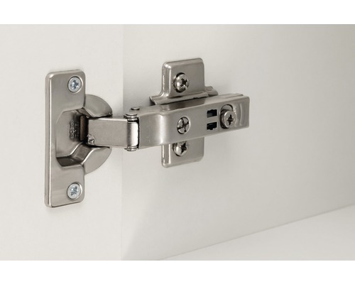 Charnière en métal fixée sur une porte blanche