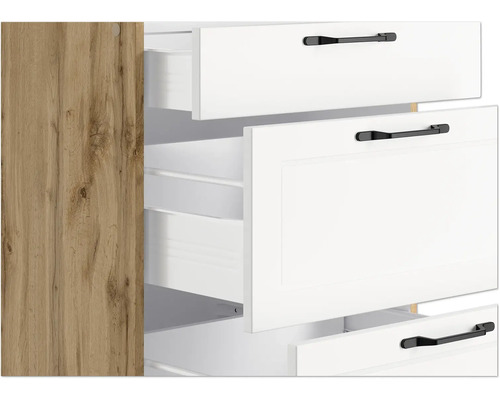 Vue détaillée d''une armoire avec des tiroirs et des poignées blancs ainsi qu''une paroi latérale aspect bois.