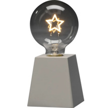 Dekorative Lampe mit sternförmiger Glühbirne auf Sockel