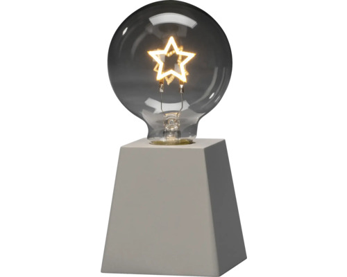 Dekorative Lampe mit sternförmiger Glühbirne auf Sockel