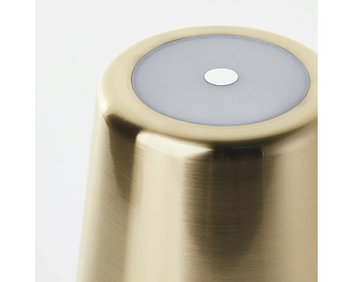 Detailaufnahme eines goldenen Lampenfußes mit grauer Abdeckung und kleinem Loch