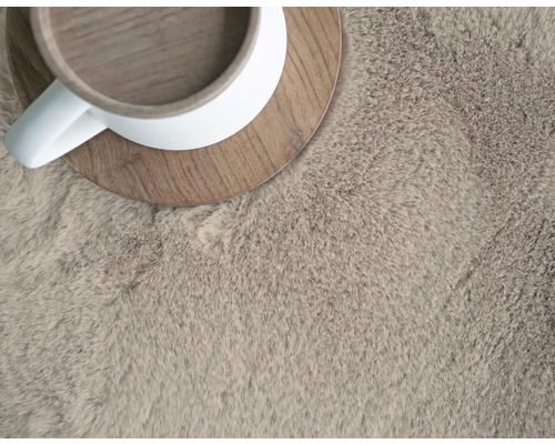 Gros plan d''un tapis à poils longs avec une tasse