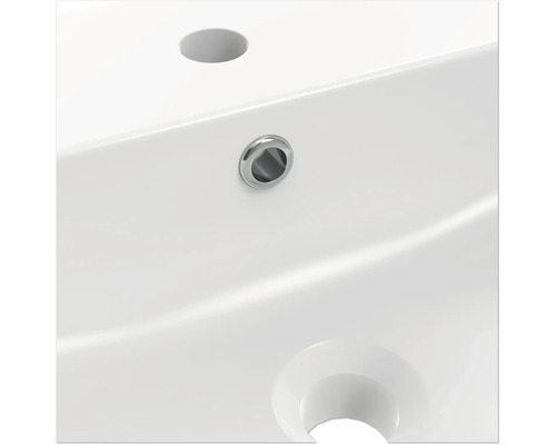 Gros plan d''un lavabo blanc avec trou de robinet et trop-plein