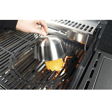 Käseburger wird auf einem Grill unter einer Schmelzglocke zubereitet